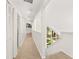 Well-lit upstairs hallway features a unique triangle window, carpet, and ample closet space at 530 Estates Pl, Longwood, FL 32779