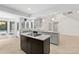 Kitchen boasts granite countertops, black appliances and large island with cooktop at 530 Estates Pl, Longwood, FL 32779