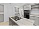 Kitchen with large island featuring granite countertops, cooktop, and stainless steel appliances at 530 Estates Pl, Longwood, FL 32779