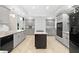 Updated kitchen with light grey cabinets, black appliances, a dark island, and tile floors at 530 Estates Pl, Longwood, FL 32779