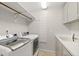 Laundry room with washer, dryer, sink, and white cabinets at 530 Estates Pl, Longwood, FL 32779