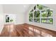 Bright living room featuring hardwood floors and large windows offering scenic outdoor views at 530 Estates Pl, Longwood, FL 32779