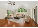 Open living room with hardwood floors, vaulted ceilings, and an abundance of natural light at 530 Estates Pl, Longwood, FL 32779