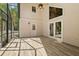 Bright screened patio with wood-look tile, ceiling fan, and access to outdoors offers versatile space at 530 Estates Pl, Longwood, FL 32779