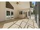 Bright screened patio with wood-look tile, ceiling fan, and access to outdoors offers versatile space at 530 Estates Pl, Longwood, FL 32779
