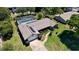 Aerial view of a single-Gathering home with a screened pool and lush landscaping at 75 Knollwood Estates Dr, Ormond Beach, FL 32174
