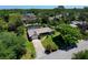 Aerial view of home showing its manicured yard, pool, landscaping, and surrounding neighborhood at 75 Knollwood Estates Dr, Ormond Beach, FL 32174