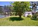 Well-manicured backyard featuring a screened-in pool and charming shed at 75 Knollwood Estates Dr, Ormond Beach, FL 32174