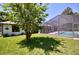 Lush backyard featuring a screened pool and mature trees at 75 Knollwood Estates Dr, Ormond Beach, FL 32174