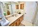 Well-lit bathroom featuring a vanity with stylish wood-grain cabinets and a neutral countertop at 75 Knollwood Estates Dr, Ormond Beach, FL 32174