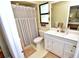 Bathroom with white vanity, framed mirror, and a shower/tub combo with neutral striped shower curtain at 75 Knollwood Estates Dr, Ormond Beach, FL 32174