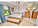 Inviting bedroom with a floral bedspread, wood furniture, neutral walls and natural light at 75 Knollwood Estates Dr, Ormond Beach, FL 32174