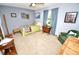 Serene bedroom with blue walls, carpet, soft natural lighting, and carefully arranged wall decor at 75 Knollwood Estates Dr, Ormond Beach, FL 32174