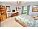 Functional bedroom features a wooden bed frame, desk, and a view of the backyard at 75 Knollwood Estates Dr, Ormond Beach, FL 32174