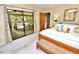 Bright bedroom with sliding glass doors to the pool area and neutral decor at 75 Knollwood Estates Dr, Ormond Beach, FL 32174
