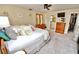 Well-lit bedroom with neutral walls and carpet, and adjacent bathroom and closet access at 75 Knollwood Estates Dr, Ormond Beach, FL 32174