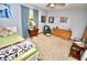 Comfortable bedroom with carpet flooring, wood furnishings, and serene blue accents for a relaxing ambiance at 75 Knollwood Estates Dr, Ormond Beach, FL 32174