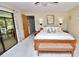 Bedroom featuring natural light, ceiling fan, neutral décor, and a sliding glass door to the patio at 75 Knollwood Estates Dr, Ormond Beach, FL 32174