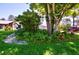 Landscaped front yard with mature trees and shrubs at 75 Knollwood Estates Dr, Ormond Beach, FL 32174
