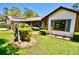 Charming single Gathering home featuring lovely front yard with green grass and tasteful landscaping at 75 Knollwood Estates Dr, Ormond Beach, FL 32174