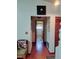 Inviting hallway featuring hardwood floors and access to a well-lit bathroom at 75 Knollwood Estates Dr, Ormond Beach, FL 32174