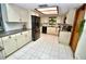 Bright kitchen with white cabinets, black appliances, and tile flooring at 75 Knollwood Estates Dr, Ormond Beach, FL 32174