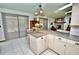 Open kitchen flows into the living area, with updated counters and tile flooring at 75 Knollwood Estates Dr, Ormond Beach, FL 32174
