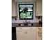 Kitchen featuring stainless sink, updated countertops, white cabinets, and backsplash at 75 Knollwood Estates Dr, Ormond Beach, FL 32174