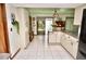 Spacious kitchen with a breakfast bar and tile floors overlooking the backyard pool area at 75 Knollwood Estates Dr, Ormond Beach, FL 32174