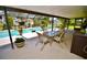 Inviting screened patio area, complete with a dining table and chairs and view of the pool at 75 Knollwood Estates Dr, Ormond Beach, FL 32174