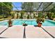 A screened-in backyard pool with lush landscaping and room for lounging at 75 Knollwood Estates Dr, Ormond Beach, FL 32174
