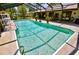 Large screened in pool with bright water, perfect for outdoor relaxation and entertaining guests at 75 Knollwood Estates Dr, Ormond Beach, FL 32174