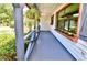 Charming porch with blue railing, white siding, and a window box with plants at 75 Knollwood Estates Dr, Ormond Beach, FL 32174