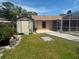 Spacious backyard featuring a shed, patio, and lush green lawn at 2612 Umbrella Tree Dr, Edgewater, FL 32141