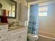 Clean bathroom featuring bright tiles, tub with shower, and modern vanity at 2612 Umbrella Tree Dr, Edgewater, FL 32141