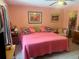 Cozy bedroom featuring a comfortable bed, ceiling fan, and decorative pillows at 2612 Umbrella Tree Dr, Edgewater, FL 32141