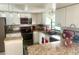 Bright kitchen featuring white cabinets, modern appliances, and granite countertops at 2612 Umbrella Tree Dr, Edgewater, FL 32141