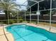 Enclosed pool offers clear, inviting waters perfect for relaxation at 2612 Umbrella Tree Dr, Edgewater, FL 32141