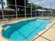 Inviting screened-in pool with clear water, surrounded by a clean deck at 2612 Umbrella Tree Dr, Edgewater, FL 32141