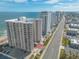 Aerial view of the condo building with oceanfront access and stunning cityscape at 2967 S Atlantic Ave # 708, Daytona Beach Shores, FL 32118