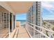Balcony view of the ocean, beach, and neighboring buildings, featuring a white railing at 2967 S Atlantic Ave # 708, Daytona Beach Shores, FL 32118