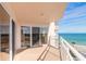 Oceanfront balcony with white railing and sliding glass door access, offering stunning views of the beach at 2967 S Atlantic Ave # 708, Daytona Beach Shores, FL 32118