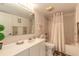 Bathroom featuring a shower-tub combo, ample lighting, and neutral tones at 2967 S Atlantic Ave # 708, Daytona Beach Shores, FL 32118