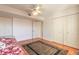 Bright bedroom featuring hardwood floors, a ceiling fan, and double closets for ample storage at 2967 S Atlantic Ave # 708, Daytona Beach Shores, FL 32118
