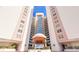 Luxury high-rise condo building with a manicured entrance and lush tropical landscaping at 2967 S Atlantic Ave # 708, Daytona Beach Shores, FL 32118