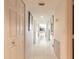 Bright hallway features white tile flooring, artwork, and neutral wall color at 2967 S Atlantic Ave # 708, Daytona Beach Shores, FL 32118