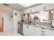 Kitchen featuring granite counters, stainless appliances, and a view to the living room at 2967 S Atlantic Ave # 708, Daytona Beach Shores, FL 32118