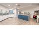 Spacious resident kitchen area with white cabinetry, a blue island and stainless appliances at 2967 S Atlantic Ave # 708, Daytona Beach Shores, FL 32118