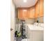 Functional laundry room with overhead cabinetry and a full-size washer and dryer at 2967 S Atlantic Ave # 708, Daytona Beach Shores, FL 32118