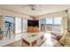 Bright living room featuring tile floors, a telescope, and sliding doors to a balcony with ocean views at 2967 S Atlantic Ave # 708, Daytona Beach Shores, FL 32118